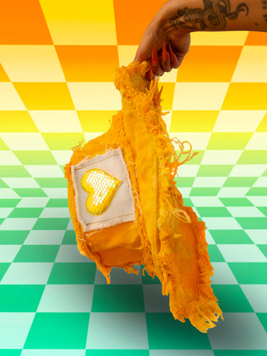 Hand Holding a Yellow Tie Dye Bucket Hat with Heart Sequin Front Stash Pocket Velcro Patch | Y2K Neon Nomade Festival Rave Fashion Upcycled Coats, Jackets, Bottles, and Accessories