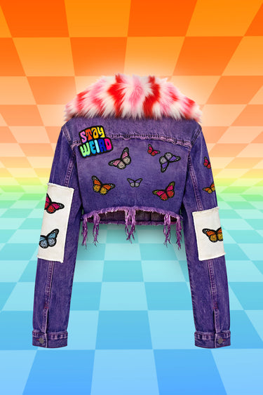 Purple Denim Cropped Jacket with Back view of Rainbow Colorful Butterfly Patches and Oversized 70's Style Confetti Pink Faux Fur Collar and Stay Weird Patch | Upcycled Festival Girly Rave Retro Style Fashion | Neon Nomade by Alyssa Risley