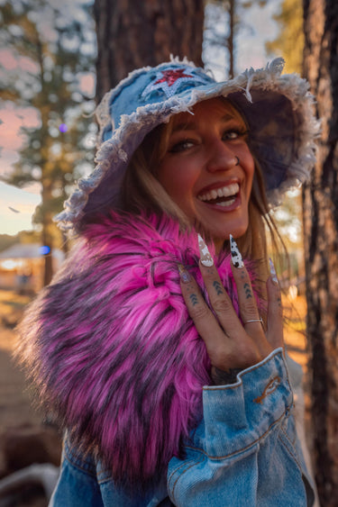 Star Bucket Hat and Mixtape Denim Cropped Jacket with Oversized 70's Style Pink Faux Fur Collar and Removable Hanging Denim Chain Straps | Festival Girly Rave Retro Style Fashion | Neon Nomade worn by Alyssa Risley in the forest at Desert Hearts