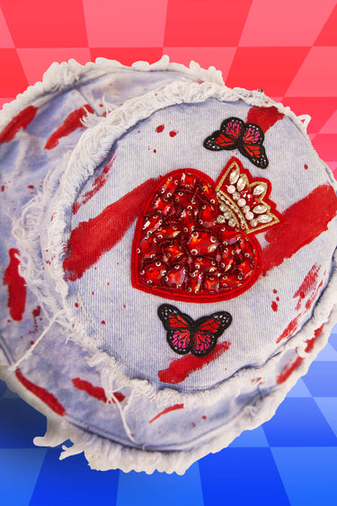 Top View of Painted Queen of Hearts Jewel Patch Faded Blue Denim Bucket Hat with Red Butterflies and Hanging Chain Strap with Frayed Distressed Edges | One of a Kind Festival Fashion for Raves Burning Man Fashion for EDC LIB Electric Forest Bass Style | Neon Nomade