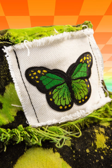 Close Up View of Butterfly Hippie Tie Dye Splatter Bleach Reverse Dye Neon Lime Green and Black Denim Bucket Hat with Front Stash Velcro Pocket and Frayed Distressed Edges | Handmade Upcycled Festival Rave Fashion Goth Fairy Fairycore Whimsigoth Punk Earthcore | Neon Nomade