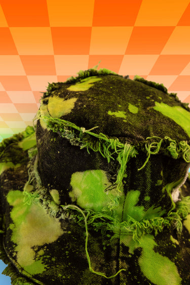 Side View of Hippie Tie Dye Splatter Bleach Reverse Dye Neon Lime Green and Black Denim Bucket Hat with Front Stash Velcro Pocket and Frayed Distressed Edges | Handmade Upcycled Festival Rave Fashion Goth Fairy Fairycore Whimsigoth Punk Earthcore | Neon Nomade